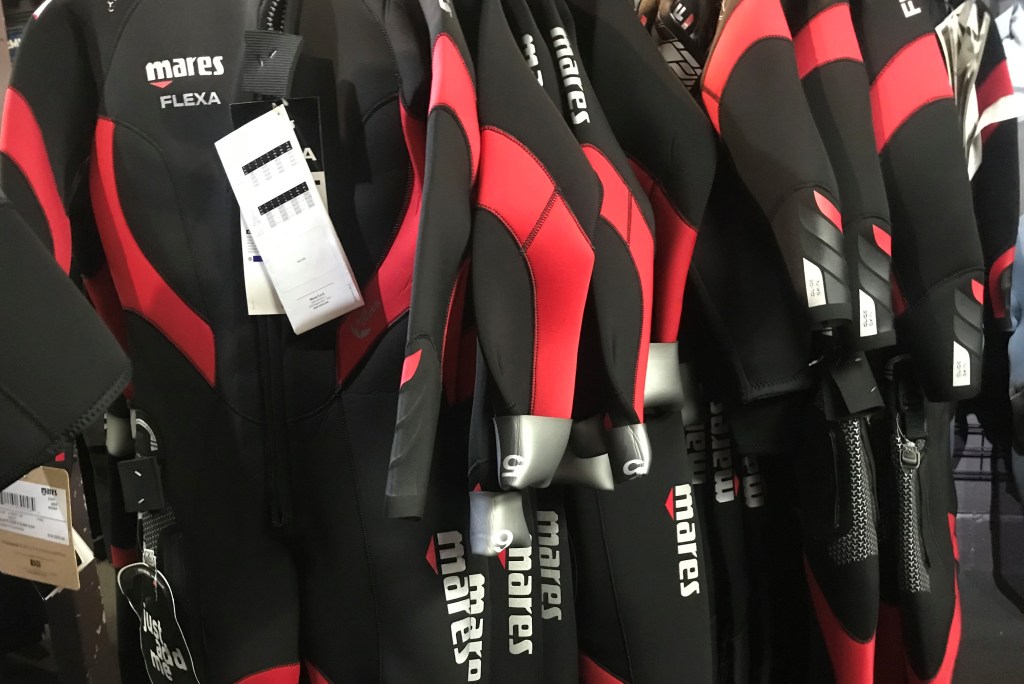 Mares Wetsuits hanging up in a shop EMPTY NEST DIVER