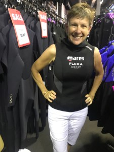Woman trying on dive vest EMPTY NEST DIVER