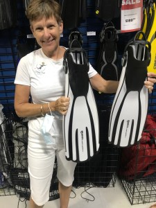 Woman holding white and black scuba fins
