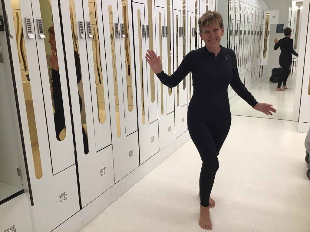 Woman in a wetsuit in Deep Dive Dubai's locker room