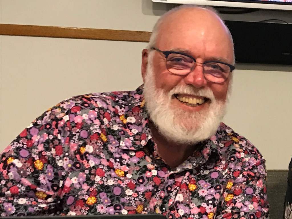 Dr Alastair Birtles looking at a laptop