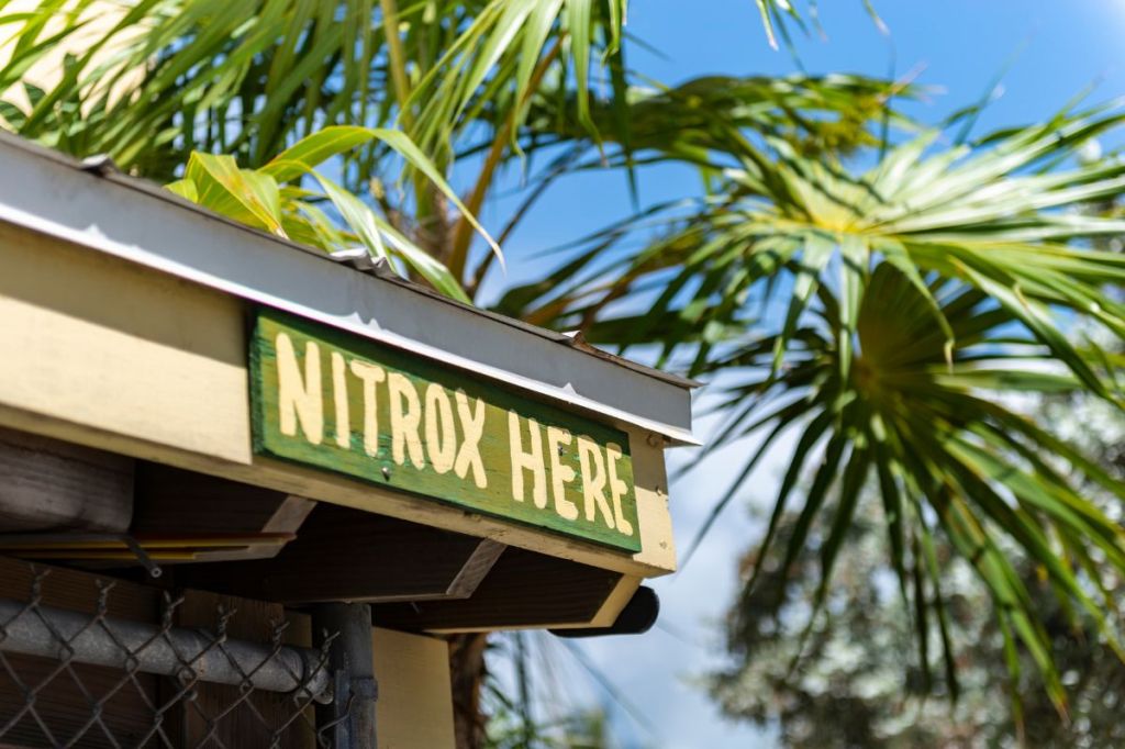 "Nitrox Here" sign on gutter of dive hut