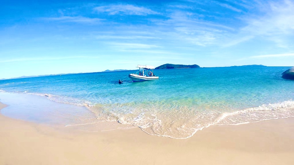 Great Keppel Island beach with a dive boat in the water.