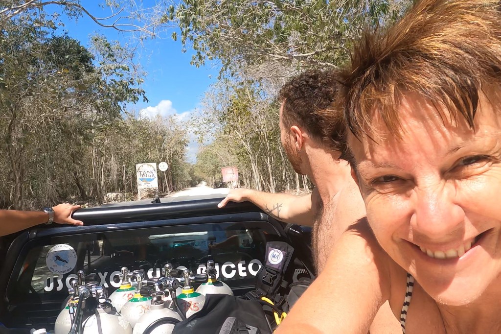 A Scuba Woman on the back of a ute with scuba tanks
emptynestdiver,com