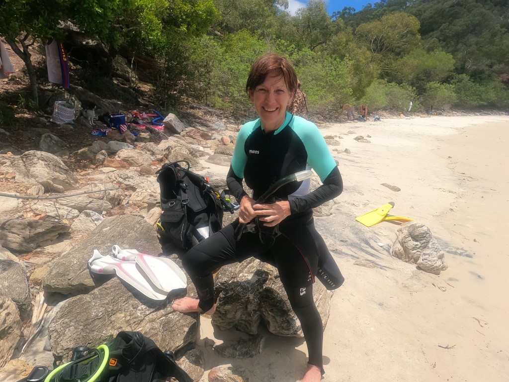 A Scuba Woman on a beach with her scuba gear
Empty Nest Diver